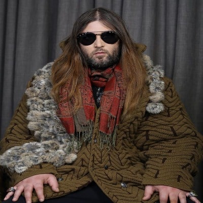 Weston Cage Coppolo in brown wooden dress with muffler and sunglass.